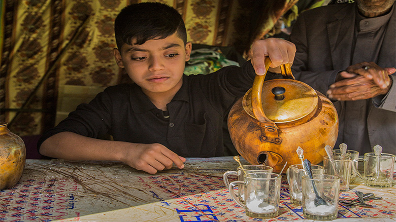 Youths serve the Arba'een pilgrims in their own special way.