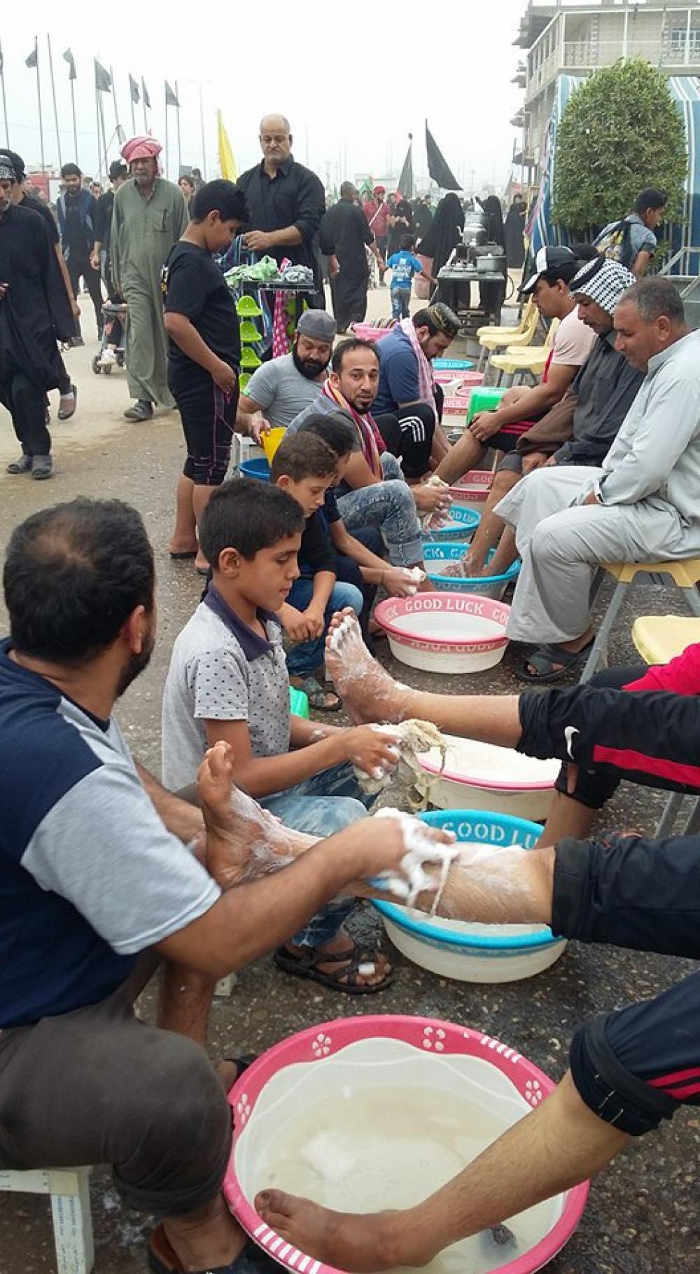 The hands are seeking the blessings of the visitors' feet.