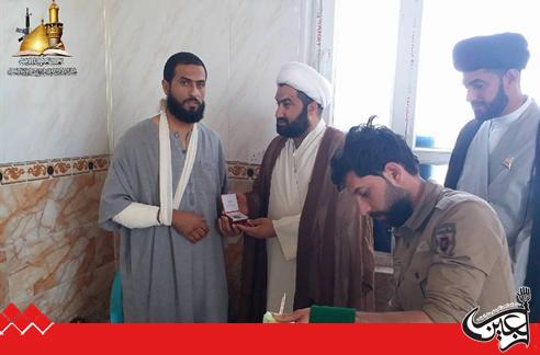 Guidance and Mobilization Committee of Imam Ali(AS) Holy Shrine visits a wounded hero.